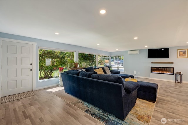 18008 Ashworth Ave N, Shoreline, WA 98133 - living area featuring recessed lighting, light wood-type flooring, baseboards, and a glass covered fireplace