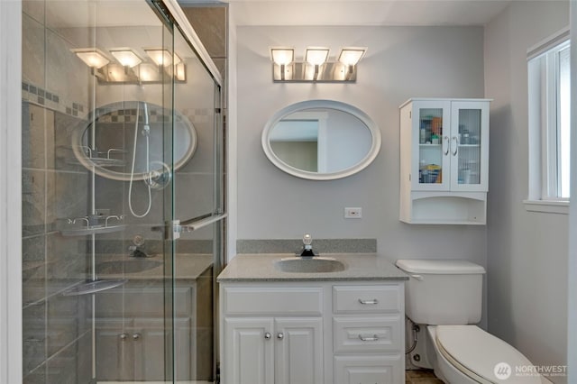 18008 Ashworth Ave N, Shoreline, WA 98133 - full bathroom featuring toilet, vanity, a stall shower, and healthy amount of natural light