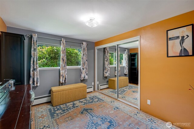 18008 Ashworth Ave N, Shoreline, WA 98133 - bedroom featuring a baseboard heating unit and a closet