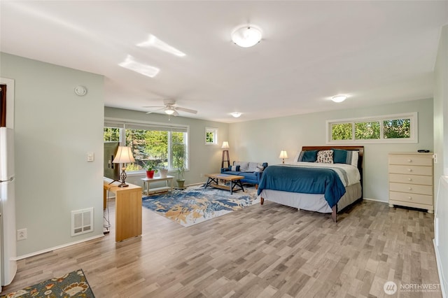 18008 Ashworth Ave N, Shoreline, WA 98133 - bedroom with light wood-style flooring, baseboards, freestanding refrigerator, and ceiling fan