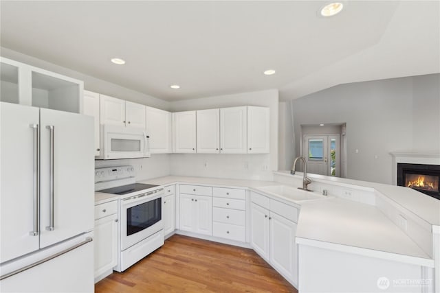 706 Finley Ln Unit S3, La Conner, WA 98257 - kitchen with white appliances, a sink, a peninsula, recessed lighting, and white cabinets