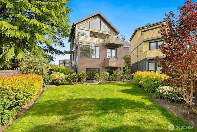 1311 Palm Ave SW, Seattle, WA 98116 - back of house featuring a balcony and a lawn