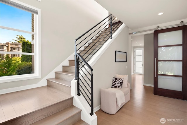 1311 Palm Ave SW, Seattle, WA 98116 - stairs featuring wood finished floors, baseboards, recessed lighting, and a barn door
