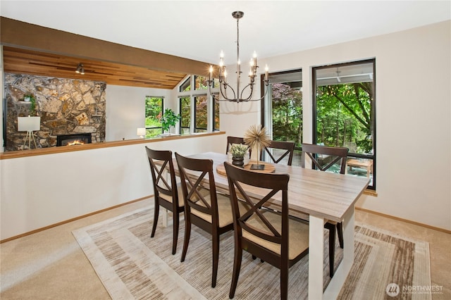 19306 SE 21st St, Sammamish, WA 98075 - carpeted dining area featuring healthy amount of natural light, a chandelier, baseboards, and a stone fireplace