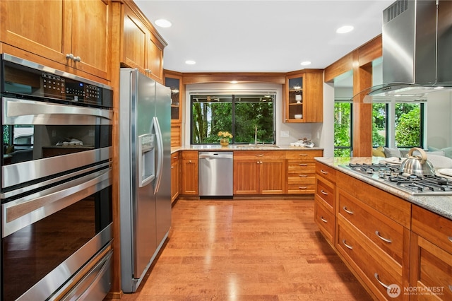 19306 SE 21st St, Sammamish, WA 98075 - kitchen with appliances with stainless steel finishes, a sink, brown cabinetry, range hood, and recessed lighting