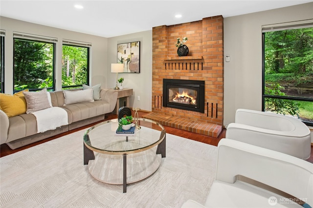 19306 SE 21st St, Sammamish, WA 98075 - living room featuring recessed lighting, a brick fireplace, and wood finished floors