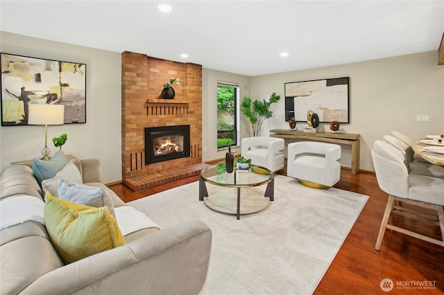 19306 SE 21st St, Sammamish, WA 98075 - living room featuring wood finished floors, recessed lighting, a brick fireplace, and baseboards