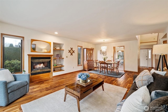 4315 Village Dr Unit B, Bellingham, WA 98226 - living room with a glass covered fireplace, wood finished floors, recessed lighting, built in shelves, and baseboards