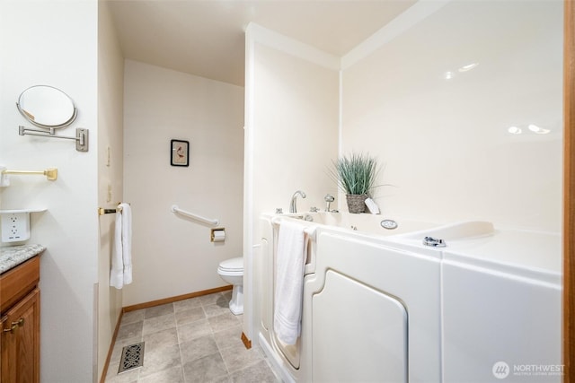 4315 Village Dr Unit B, Bellingham, WA 98226 - bathroom featuring vanity, toilet, a bath, and baseboards