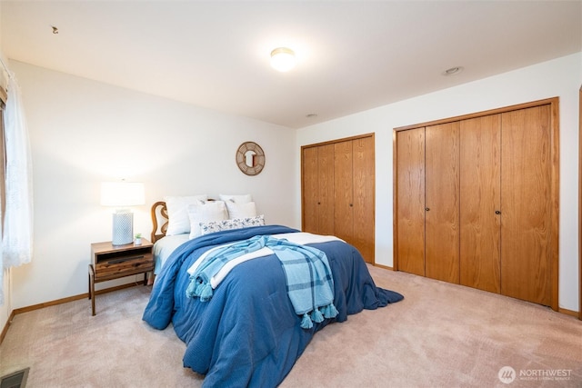 4315 Village Dr Unit B, Bellingham, WA 98226 - bedroom featuring two closets, light colored carpet, and baseboards