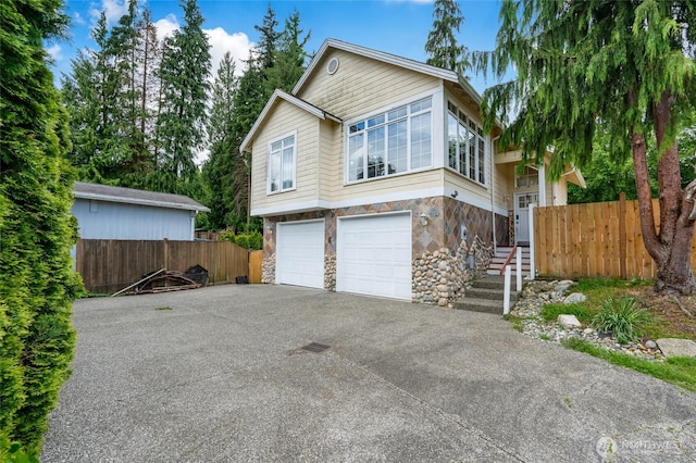 1014 W Mukilteo Blvd, Everett, WA 98203 - view of front of property featuring stone siding, an attached garage, and driveway