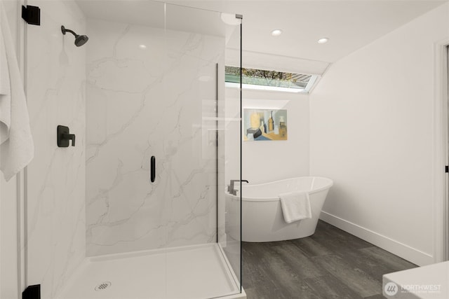 21024 NE 36th St, Sammamish, WA 98074 - bathroom featuring a marble finish shower, a freestanding bath, wood finished floors, recessed lighting, and baseboards
