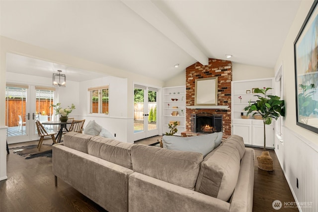 21024 NE 36th St, Sammamish, WA 98074 - living area featuring french doors, dark wood finished floors, a brick fireplace, and healthy amount of natural light
