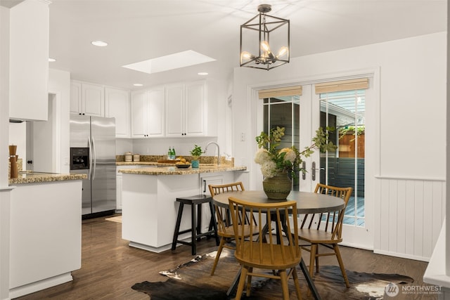 21024 NE 36th St, Sammamish, WA 98074 - dining room with a skylight, dark wood-style flooring, recessed lighting, and a chandelier