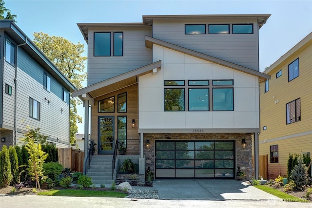 15535 NE 60th St, Redmond, WA 98052 - modern home with concrete driveway, an attached garage, and stone siding