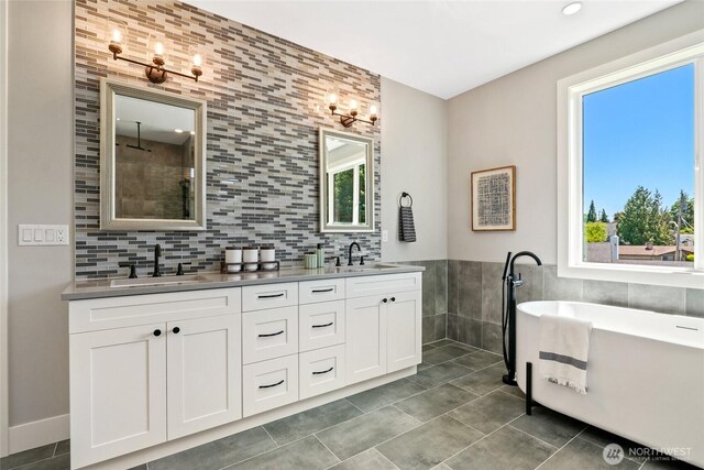 15535 NE 60th St, Redmond, WA 98052 - full bath featuring tile walls, double vanity, a freestanding tub, and tile patterned flooring