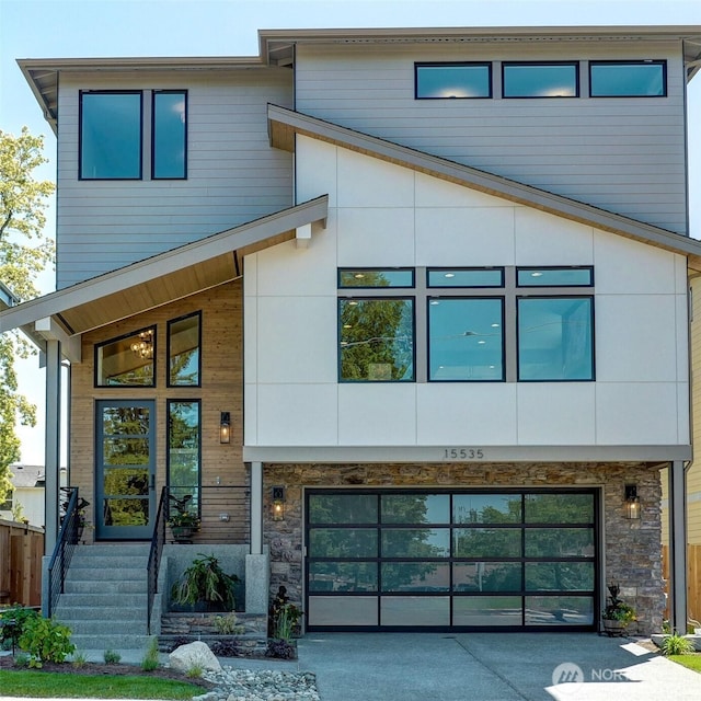 15535 NE 60th St, Redmond, WA 98052 - contemporary house featuring driveway, stone siding, and a garage