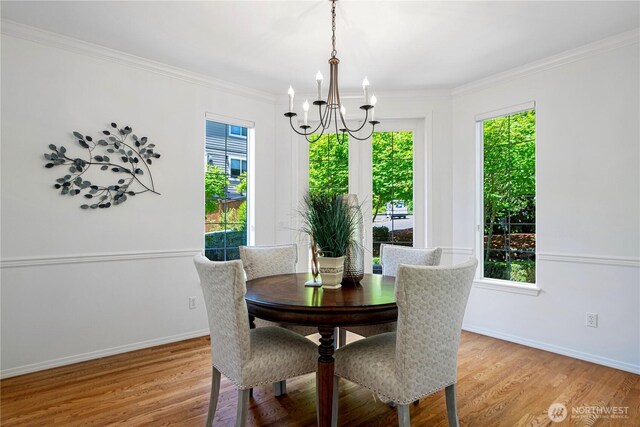 7817 NE 112th St, Kirkland, WA 98034 - dining area with a chandelier, healthy amount of natural light, light wood-type flooring, and ornamental molding