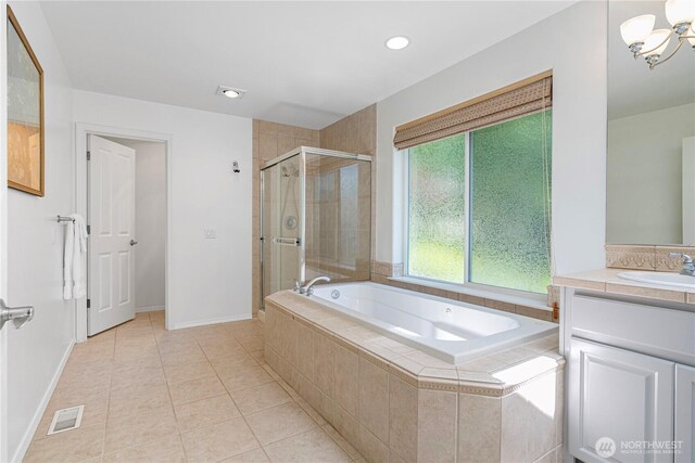 7817 NE 112th St, Kirkland, WA 98034 - full bath featuring a garden tub, vanity, a shower stall, tile patterned flooring, and a chandelier