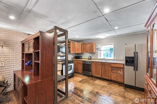 8445 Golden Valley Dr, Maple Falls, WA 98266 - kitchen with stainless steel appliances, a sink, brick wall, light countertops, and open shelves