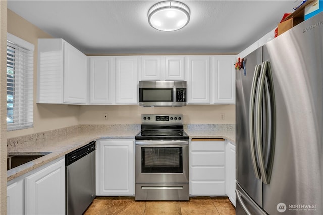 11102 NE 125th Ln Unit K136, Kirkland, WA 98034 - kitchen featuring stainless steel appliances, white cabinets, light tile patterned floors, and light stone countertops