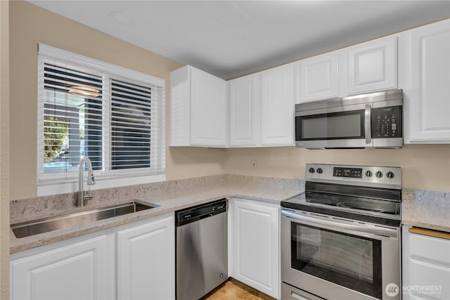 11102 NE 125th Ln Unit K136, Kirkland, WA 98034 - kitchen with appliances with stainless steel finishes, a sink, white cabinets, and light stone counters