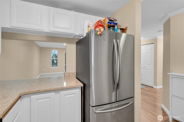 11102 NE 125th Ln Unit K136, Kirkland, WA 98034 - kitchen featuring freestanding refrigerator, white cabinets, light wood-style floors, crown molding, and light stone countertops