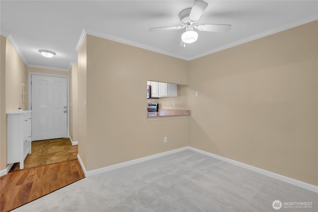 11102 NE 125th Ln Unit K136, Kirkland, WA 98034 - spare room featuring crown molding, ceiling fan, baseboards, and light carpet