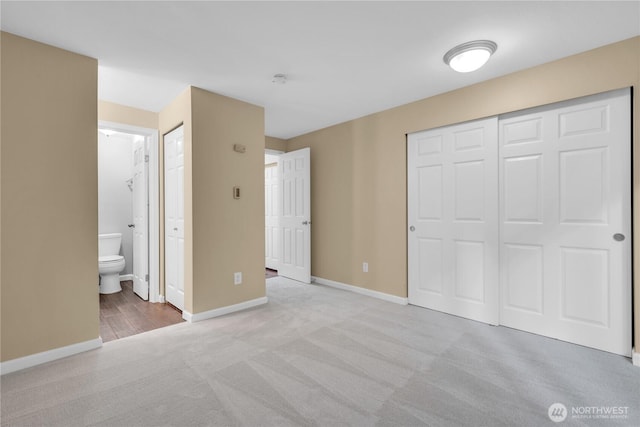 11102 NE 125th Ln Unit K136, Kirkland, WA 98034 - unfurnished bedroom with carpet flooring, baseboards, ensuite bath, and a closet