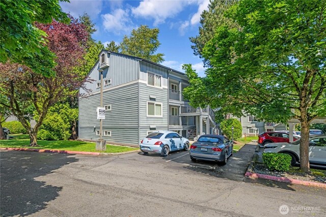11102 NE 125th Ln Unit K136, Kirkland, WA 98034 - view of front facade featuring stairway and uncovered parking