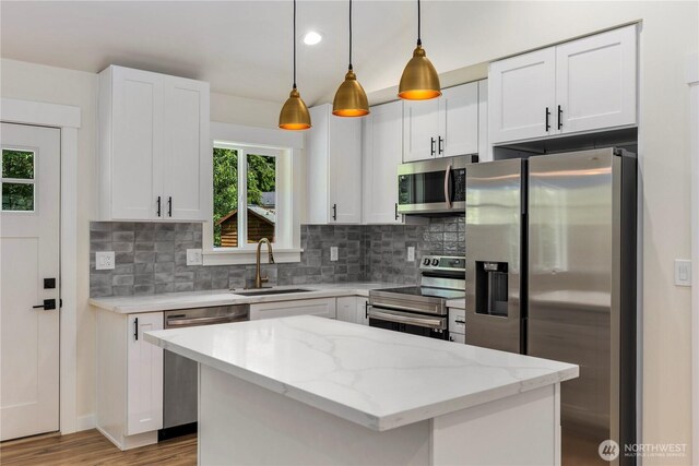401 Flair Valley Ct, Maple Falls, WA 98266 - kitchen with stainless steel appliances, a sink, backsplash, white cabinets, and light stone counters