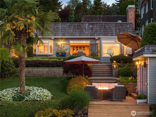 17834 SE 40th Pl, Bellevue, WA 98008 - back of property with an outdoor fire pit, a wooden deck, and a yard