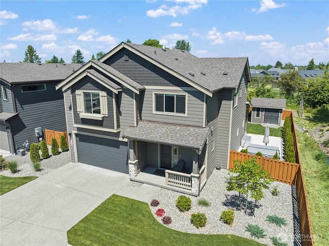208 Hovey St, Buckley, WA 98321 - view of front of house featuring a porch, concrete driveway, roof with shingles, and a garage