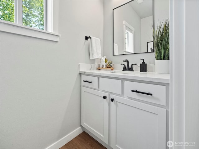 208 Hovey St, Buckley, WA 98321 - bathroom with vanity, baseboards, and wood finished floors