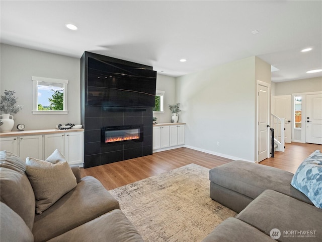 208 Hovey St, Buckley, WA 98321 - living area featuring light wood-style flooring, recessed lighting, healthy amount of natural light, a fireplace, and baseboards