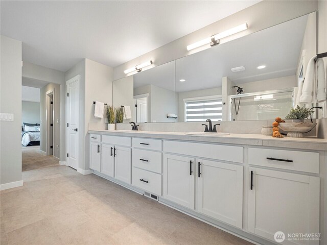 208 Hovey St, Buckley, WA 98321 - ensuite bathroom with double vanity, tiled shower, baseboards, and recessed lighting
