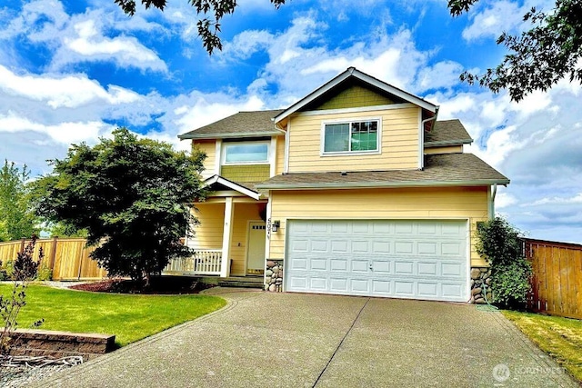 507 Sorenson St, Buckley, WA 98321 - traditional-style house featuring driveway, a garage, covered porch, and stone siding