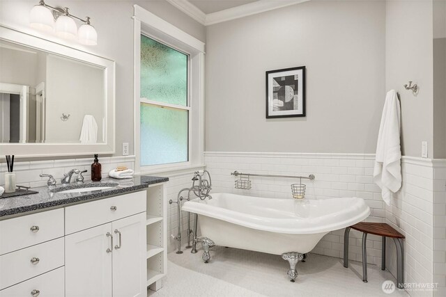 11005 NE 100th Pl, Kirkland, WA 98033 - bathroom featuring a soaking tub, tile walls, vanity, wainscoting, and ornamental molding
