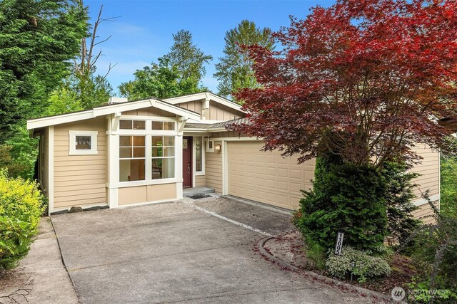 11005 NE 100th Pl, Kirkland, WA 98033 - view of front facade featuring driveway and an attached garage