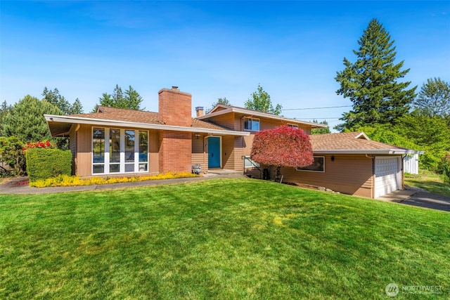 1981 Sequoia St SE, Port Orchard, WA 98366 - back of property with a chimney, a yard, and driveway