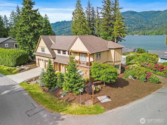 20 Longshore Ln, Bellingham, WA 98229 - view of front of property featuring an attached garage, driveway, board and batten siding, a water and mountain view, and stone siding
