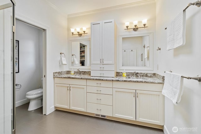 20 Longshore Ln, Bellingham, WA 98229 - full bathroom with double vanity, toilet, ornamental molding, baseboards, and tile patterned flooring