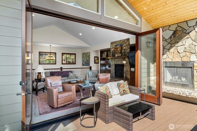 20 Longshore Ln, Bellingham, WA 98229 - living area with a stone fireplace, wood-type flooring, high vaulted ceiling, and recessed lighting