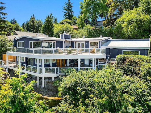 7440 SE 32nd St, Mercer Island, WA 98040 - back of property featuring a balcony, a chimney, a deck, and view of wooded area