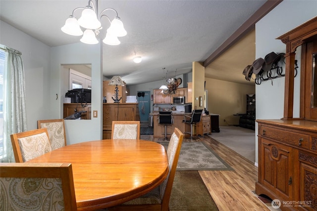 8321 S Main St, Lyman, WA 98263 - dining area with a chandelier, light wood finished floors, and lofted ceiling