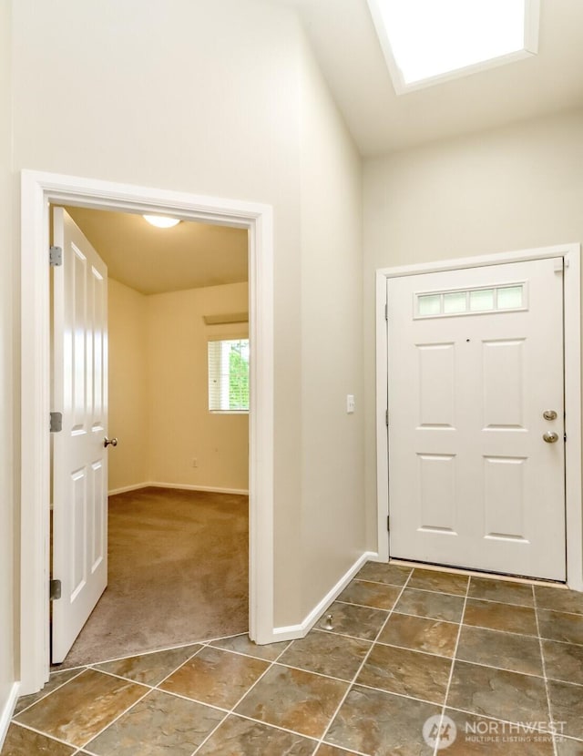 5513 Starlight St E, Fife, WA 98424 - entryway with baseboards, dark colored carpet, and dark tile patterned floors