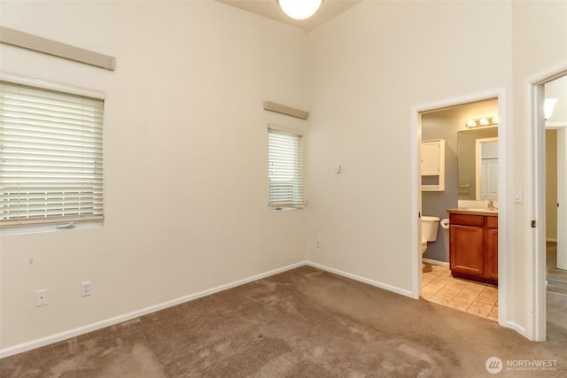 5513 Starlight St E, Fife, WA 98424 - unfurnished bedroom featuring light colored carpet, a sink, baseboards, and ensuite bathroom
