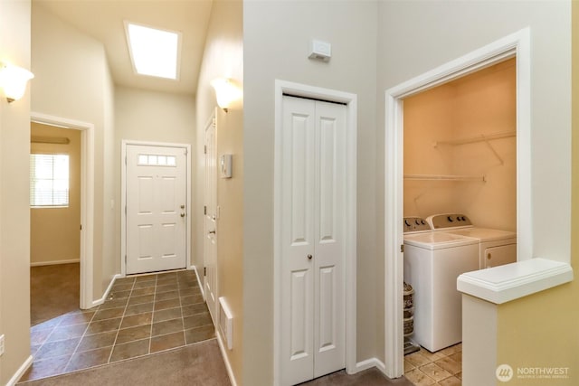 5513 Starlight St E, Fife, WA 98424 - laundry room with washer and dryer, tile patterned floors, baseboards, carpet, and a towering ceiling