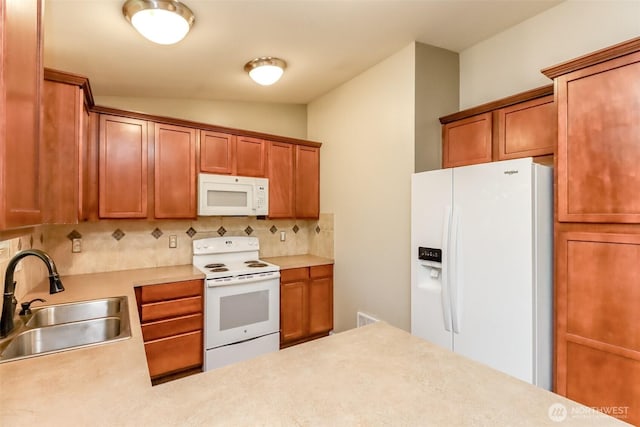 5513 Starlight St E, Fife, WA 98424 - kitchen with white appliances, a sink, decorative backsplash, vaulted ceiling, and light countertops