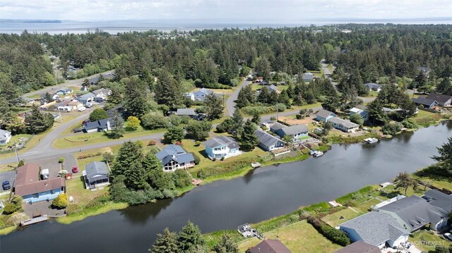 393 Canal Dr SE, Ocean Shores, WA 98569 - aerial view of property and surrounding area with nearby suburban area, a large body of water, and a forest
